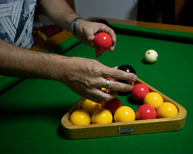 Using the standard triangle to rack pool balls